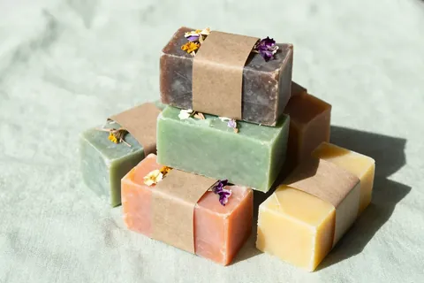 Stack of colorful handmade soap bars with paper bands